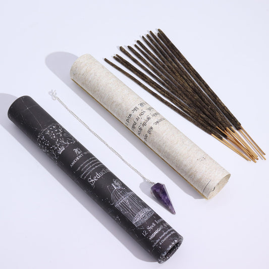 Ancient Witch Spell Incense: Seduction with Amethyst Pendulum and Midnight Oud, black tube, scroll, incense sticks.